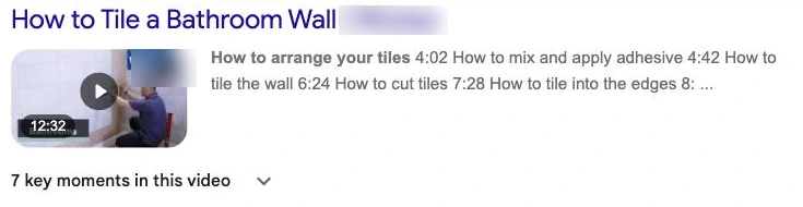 A Google search result with a video thumbnail, timestamps and 7 key moments, for how to tile a bathroom wall
